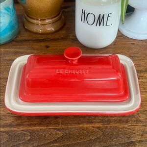 Le Creuset Stoneware Cerise Red Butter Dish with Lid Under Plate